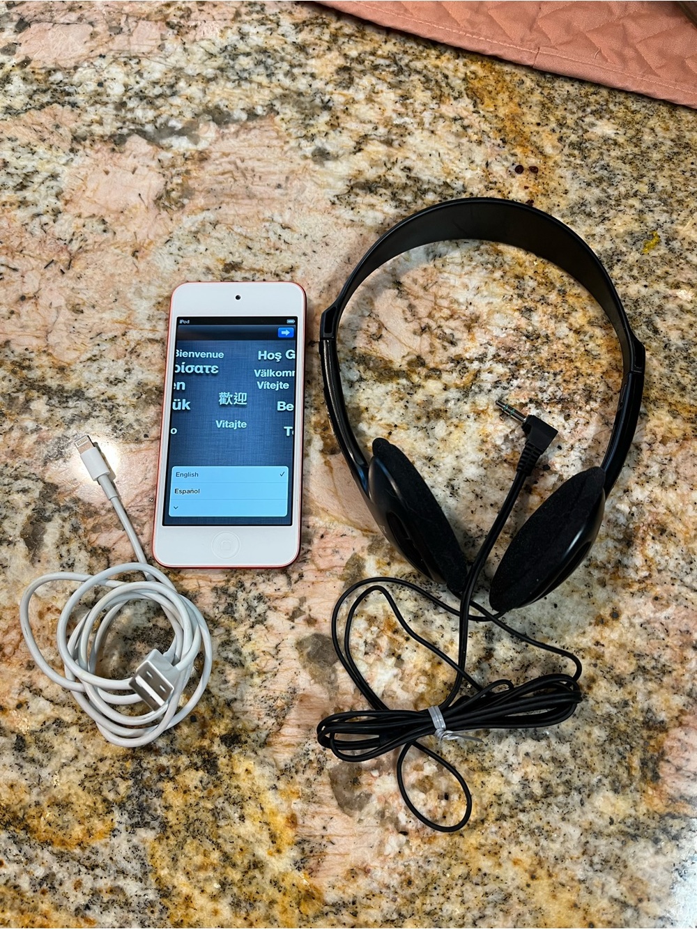 Apple Pink iPod Touch with Black Headphones and White Charging Cable